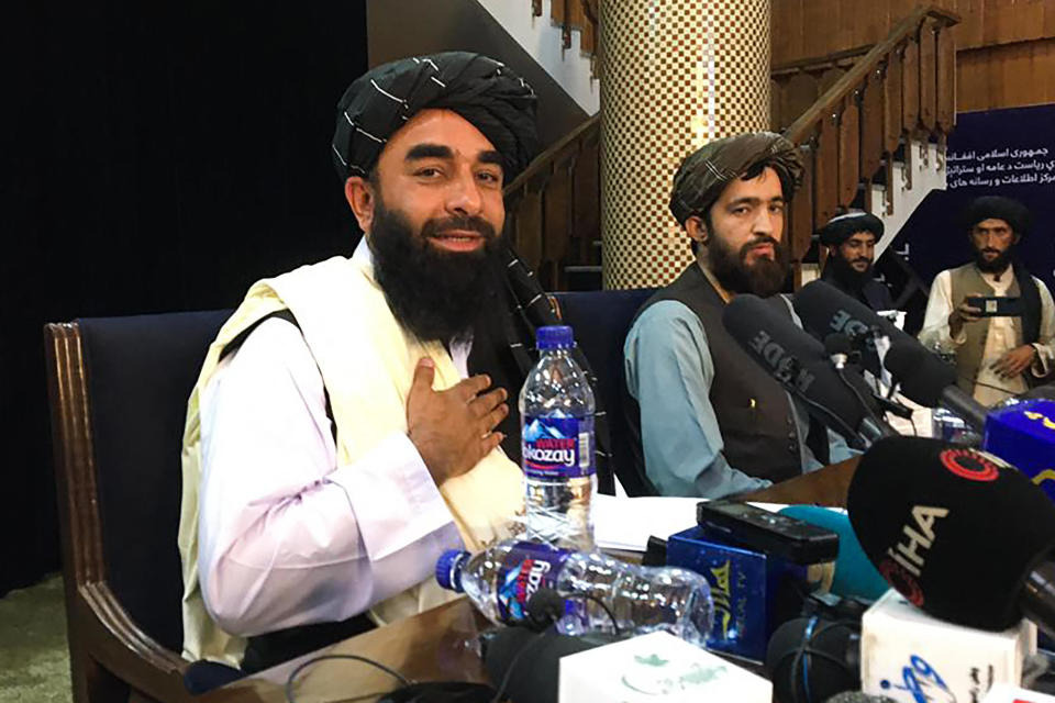 Taliban spokesman Zabihullah Mujahid, left, at the first press conference in Kabul following their stunning takeover of Afghanistan, August 17, 2021. / Credit: HOSHANG HASHIMI/AFP via Getty Images