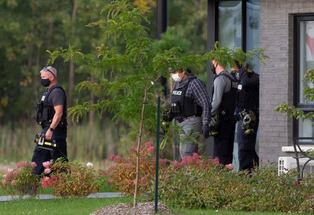 Canadian police investigators exit a residential building in Quebec that was related to a probe into ricin-filled envelopes sent to the White House and to Texas officials in 2020.