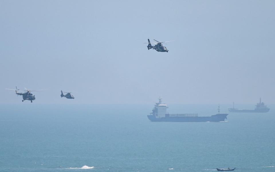 Chinese military helicopters carrying out military exercises off Taiwan in August. The US, Australia and Japan have become growingly concerned about China's aggression - Hector Retamal/AFP via Getty Images