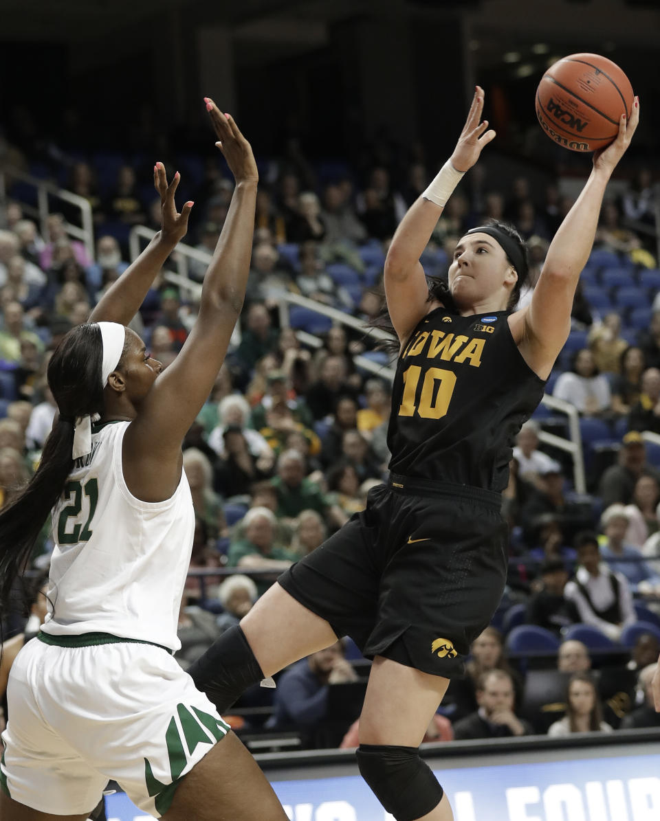 Iowa's Megan Gustafson (10) shoots against Baylor's Kalani Brown (21) during the first half of a regional final women's college basketball game in the NCAA Tournament in Greensboro, N.C., Monday, April 1, 2019. (AP Photo/Chuck Burton)