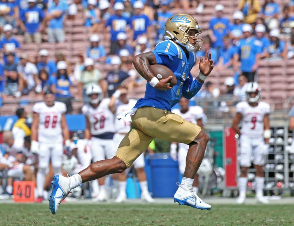 UCLA quarterback Dorian Thompson-Robinson runs for a five-yard gain.