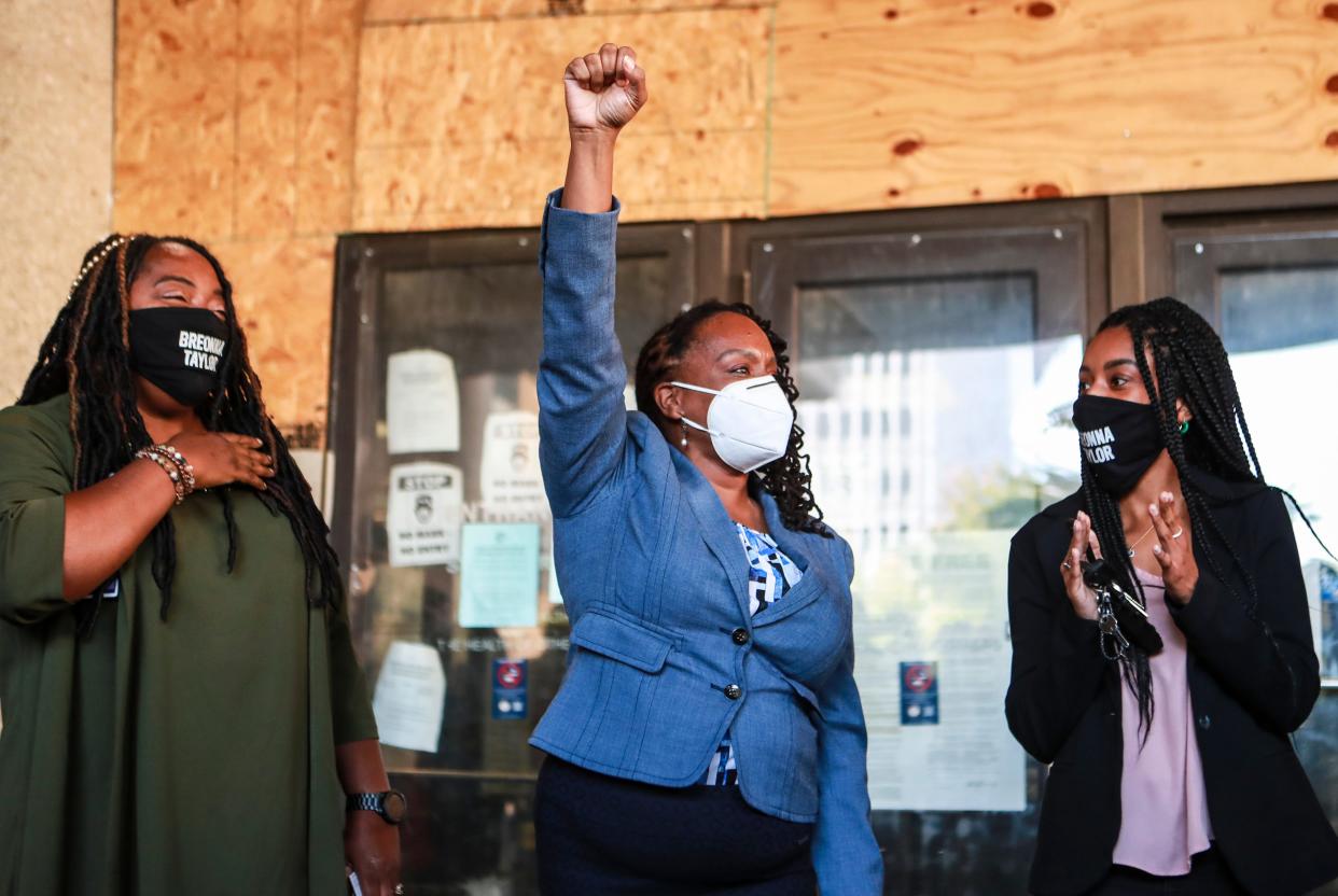 Then-state Rep. Attica Scott raised her fist as she left the Louisville Hall of Justice after an arraignment in October 2020 over an arrest at a protest, alongside Shameka Parrish-Wright (left) and Ashanti Scott. Rioting charges had been dropped in court that morning.