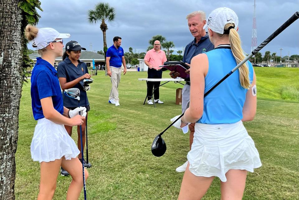 Starter Lee Smith of the Jacksonville Beach Golf Club goes over the order of play on the first tee before the start of the Jacksonville Beach Varsity Invitational on Saturday. The players (from the left) are Sadaly Campbell of Fernandina Beach, Sahana Chokshi of Episcopal and Nancy Cox of Ponte Vedra.