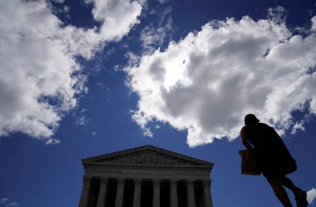 A woman walks toward the U.S. Supreme Court in Washington