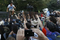 A protester climbs over the fence near the AT&T Station in Philadelphia, Tuesday, July 26, 2016, during the second day of the Democratic National Convention. (Photo: Alex Brandon/AP)