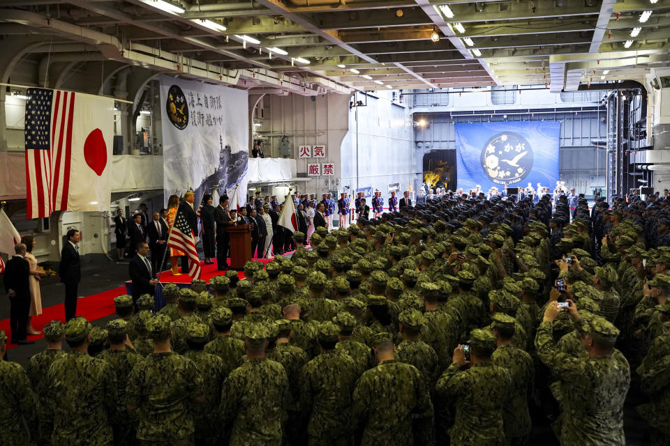 FILE - In this May 28, 2019, file photo, Japanese Prime Minister Shinzo Abe delivers a speech to Japanese and U.S. troops with U.S. President Donald Trump as they aboard Japan Maritime Self-Defense Force's (JMSDF) helicopter carrier DDH-184 Kaga at Yokosuka base in Yokosuka, south of Tokyo. Japan approved Friday, Dec. 20, 2019, a draft defense budget that included cost to develop own fighter jets to succeed the nation's aging warplanes and import some of F-35 stealth fighters as components for assembly at home rather than importing the expensive American warplanes as finished products to reduce costs and acquire expertise. Japan's defense spending has risen for seven consecutive years by a total of 13%, beginning a year after Abe took office in December 2012. (Athit Perawongmetha/Pool Photo via AP, File)