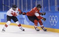 Ice Hockey – Pyeongchang 2018 Winter Olympics – Men Preliminary Round Match - Switzerland v Canada - Kwandong Hockey Centre, Gangneung, South Korea – February 15, 2018 - Maxim Noreau of Canada (L) in action against Reto Schappi of Switzerland. REUTERS/David W Cerny