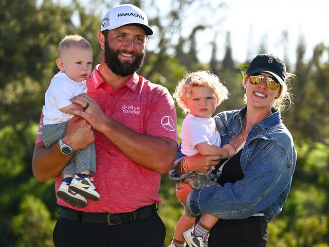 <p>Tracy Wilcox/PGA TOUR/Getty</p> Jon Rahm, and Kelley Cahill with their kids Eneko and Kepa during the trophy ceremony of the Sentry Tournament of Champions on January 8, 2023 in Kapalua, Maui, Hawaii.