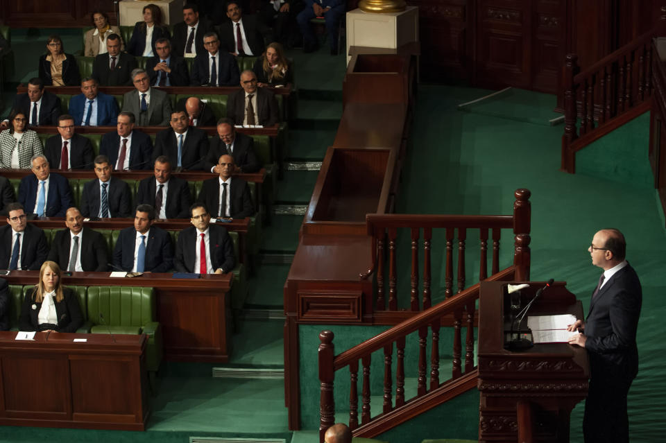 Tunisian designated Prime Minister Elyes Fakhfakh, right, delivers his speech at the parliament, Wednesday, Feb. 26, 2020. Tunisia's parliament is expected to hold a confidence vote Wednesday on designated prime minister Elyes Fakhfakh's government. (AP Photo/Hassene Dridi)