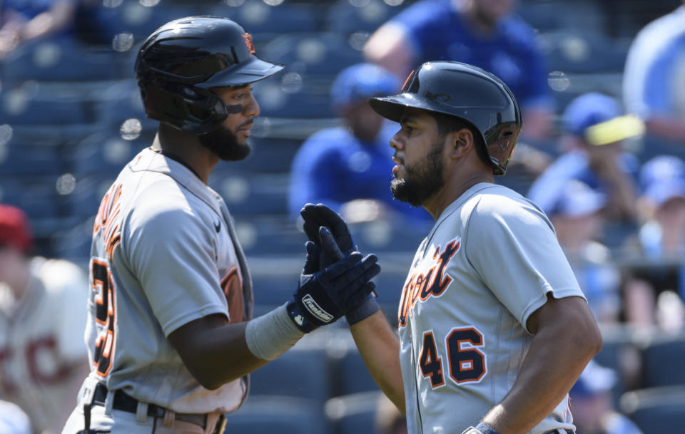 The Detroit Tigers' Jeimer Candelario, right, is congratulated by teammate Niko Goodrum, left, after scoring against the Kansas City Royals during the ninth inning of a baseball game in Kansas City, Mo., Wednesday, June 16, 2021. (AP Photo/Reed Hoffmann)