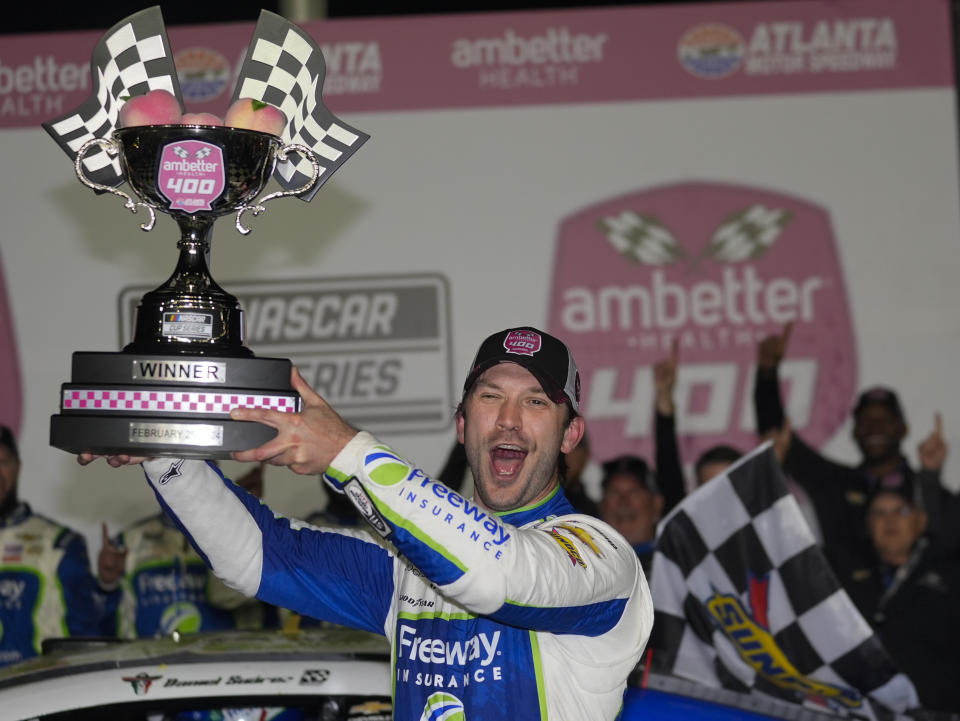 Daniel Suarez holds trophy after winning the NASCAR auto race at Atlanta Motor Speedway Sunday, Feb. 25, 2024, in Hampton , Ga. (AP Photo/John Bazemore)