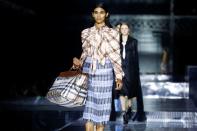 Models present creations during the Burberry catwalk show at London Fashion Week in London