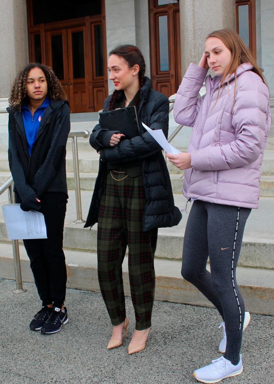 High school track athletes Alanna Smith, left, Selina Soule, center and and Chelsea Mitchell prepare to speak at a news conference outside the Connecticut State Capitol in Hartford, Connecticut in  2020. The three athletes filed a federal lawsuit to block a state policy that allows transgender athletes to compete in girls sports.