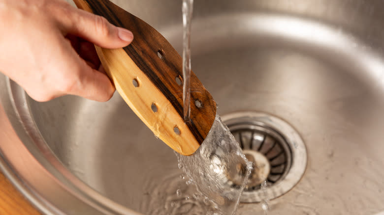 washing a wooden spoon