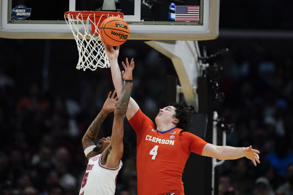 Clemson forward Ian Schieffelin (4) reaches for a rebound over Alabama guard Aaron Estrada during the first half of an Elite 8 college basketball game in the NCAA tournament Saturday, March 30, 2024, in Los Angeles. (AP Photo/Ryan Sun)