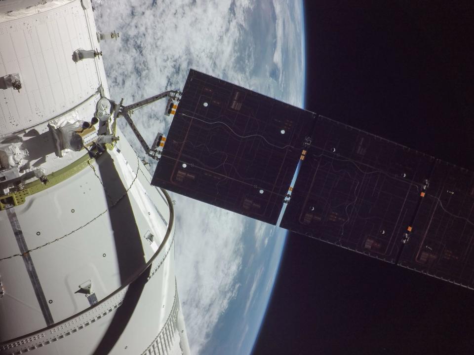 spaceship solar array high above earth in space