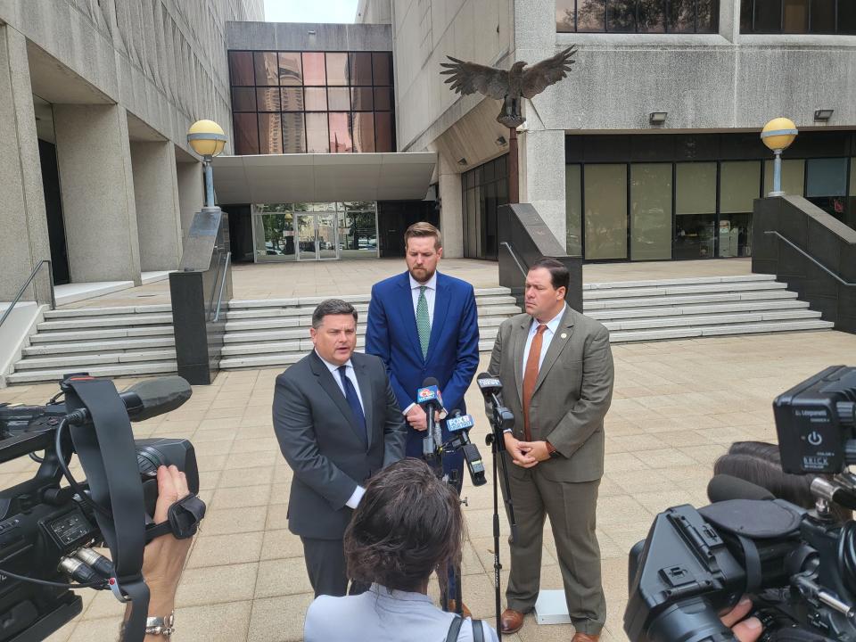 Witnesses in the state lawsuit against FEMA speak to reporters during recess. Left to right: Casey Tingle, Matthew Jewell, and Archie Chaisson.