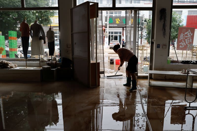 Wang Dan at a clothing store after rain and floods in Zhuozhou