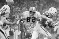 FILE - In this Dec. 26, 1971, file photo, Cleveland Browns linebacker Jim Houston (82) chases after Baltimore Colts wide receiver Ray Perkins during a football game in Cleveland. Houston's widow would keep notes on her husband's deteriorating condition in a three-ring binder so she would be prepared for the day when he needed full-time care. (AP Photo/FIle)