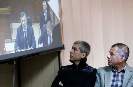 Jury members attend the trial of former riot police force members suspected of killing participants of the 2014 anti-government and pro-European Union mass protests, as Ukraine's former President Viktor Yanukovich giving evidence via a video link is seen on the screen, at a court building in Kiev, Ukraine, November 25, 2016. REUTERS/Valentyn Ogirenko
