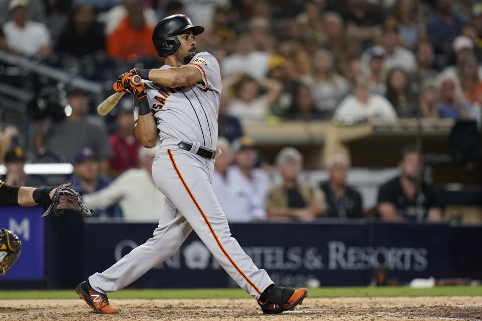 San Francisco Giants' LaMonte Wade Jr. watches his RBI-single hit during the ninth inning of a baseball game against the San Diego Padres, Tuesday, Sept. 21, 2021, in San Diego. (AP Photo/Gregory Bull)