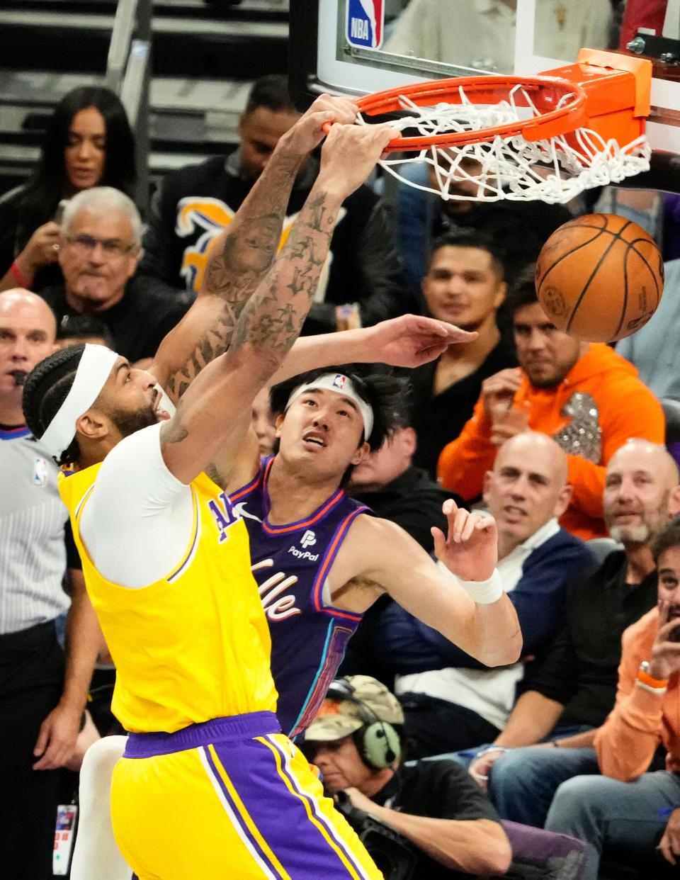 Los Angeles Lakers forward Anthony Davis (3) slam-dunks the ball over Phoenix Suns forward Yuta Watanabe (18) in the first half of the in-season tournament game at Footprint Center in Phoenix on Nov. 10, 2023.