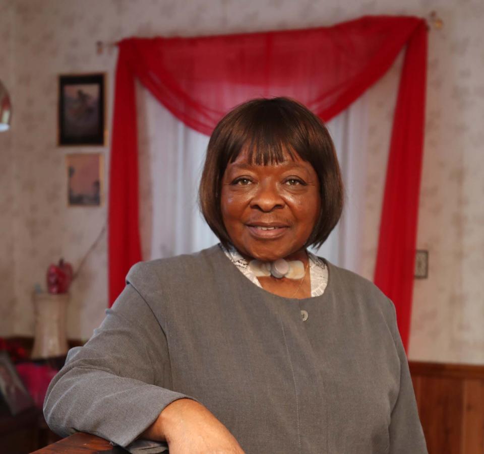 Lovie Moore takes a portrait in the home that has been owned by her family since she was a child. She blames the depreciation of the home on the construction of the nearby Akron Innerbelt.