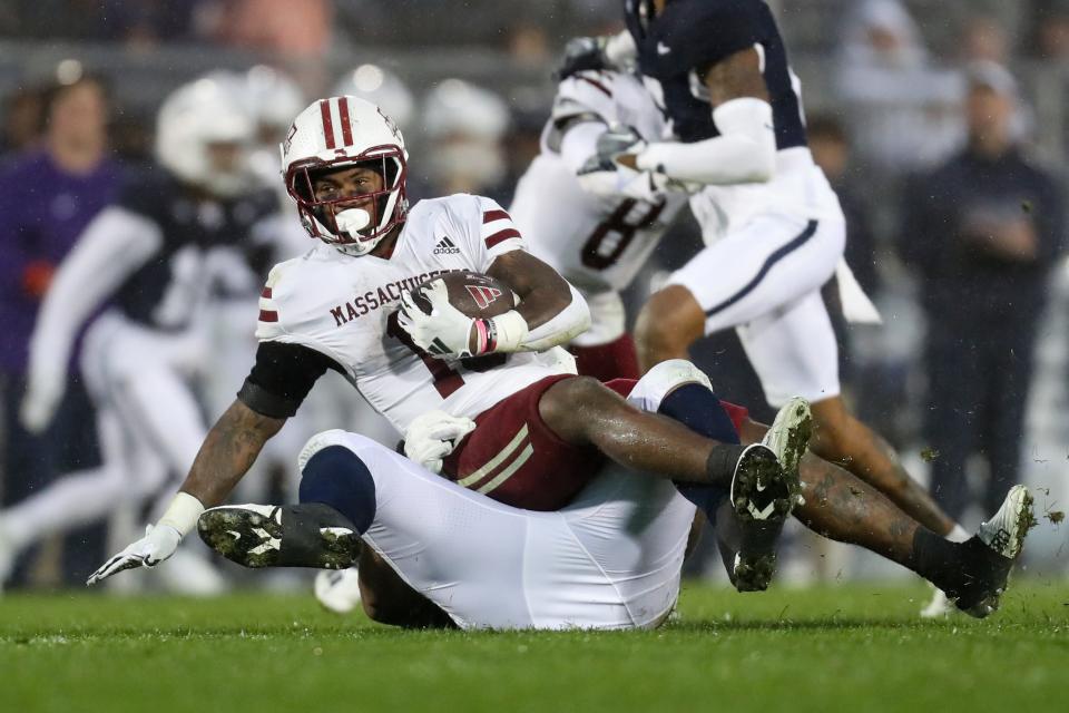 Oct 14, 2023; University Park, Pennsylvania, USA; Massachusetts Minutemen running back Kay'Ron Lynch-Adams (15) is tackled by Penn State Nittany Lions defensive tackle Dvon Ellies (91) during the third quarter at Beaver Stadium. Penn State won 63-0. Mandatory Credit: Matthew O'Haren-USA TODAY Sports