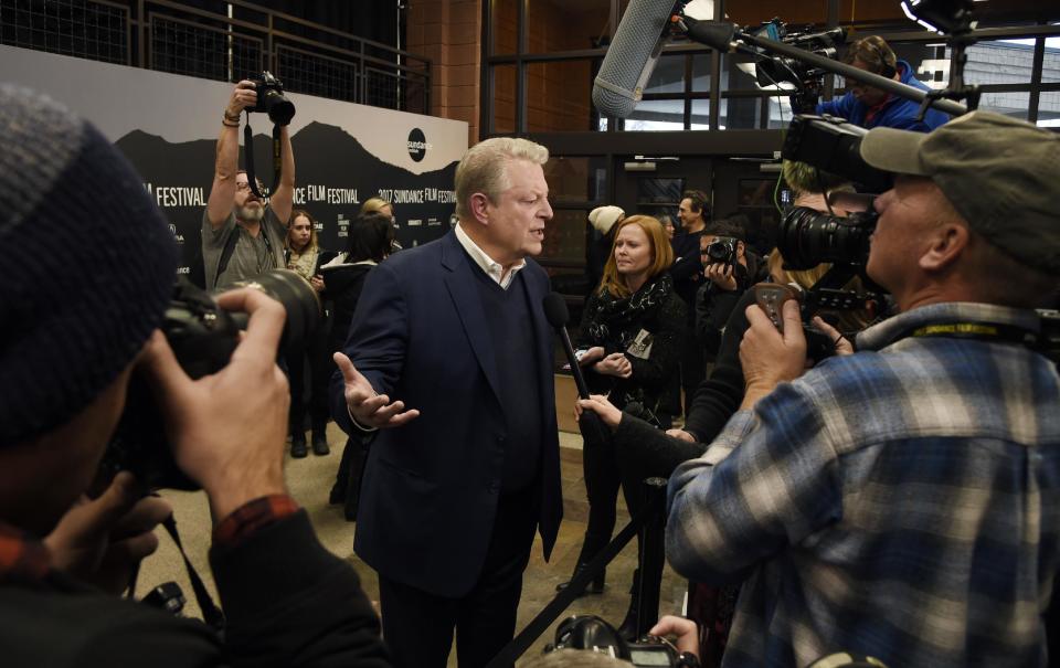 Former U.S. Vice President Al Gore, center, is surrounded by media at the premiere of the film "An Inconvenient Sequel: Truth to Power," at the Eccles Theater during the 2017 Sundance Film Festival on Thursday, Jan. 19, 2017, in Park City, Utah. (Photo by Chris Pizzello/Invision/AP)