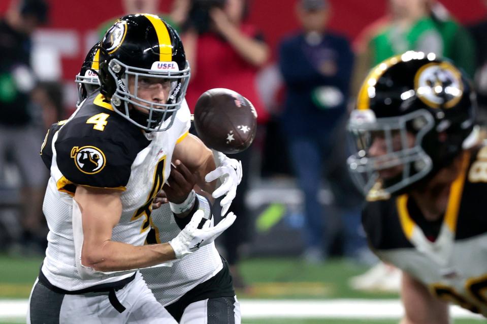 Pittsburgh Maulers Bailey Gaither bobbles the football on a handoff during their game at Ford Field in Detroit on Saturday, May 13, 2023. The Maulers beat the Panthers, 23-7.