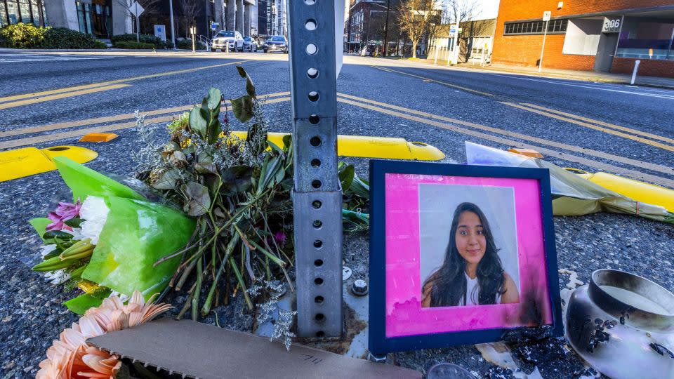 A photo of Jaahnavi Kandula is displayed with flowers on January 29 at the intersection where she was killed. - Ken Lambert/The Seattle Times/AP