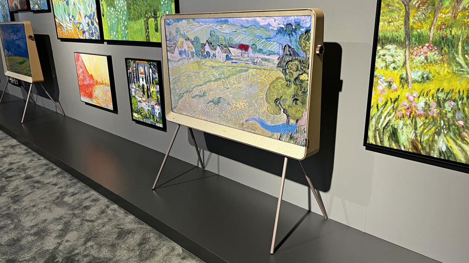 Hisense R7K TV standing among lots of famous works of art