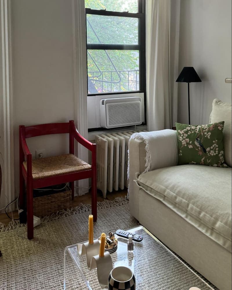 Red arm chair in corner of apartment.