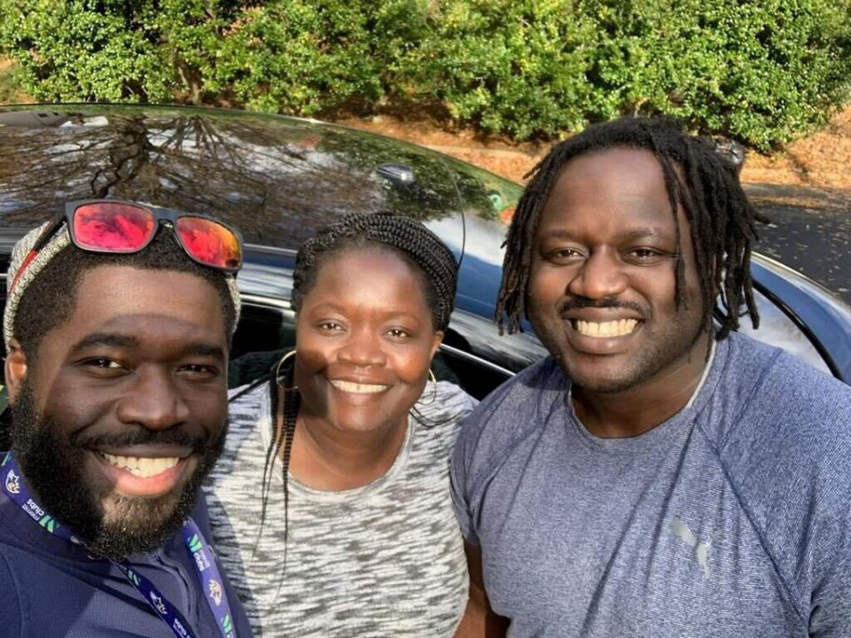 Irvo Otieno, right, with his mother, Caroline Ouko, and his older brother, Leon Ochieng, who is taking the selfie in front of a passenger vehicle.