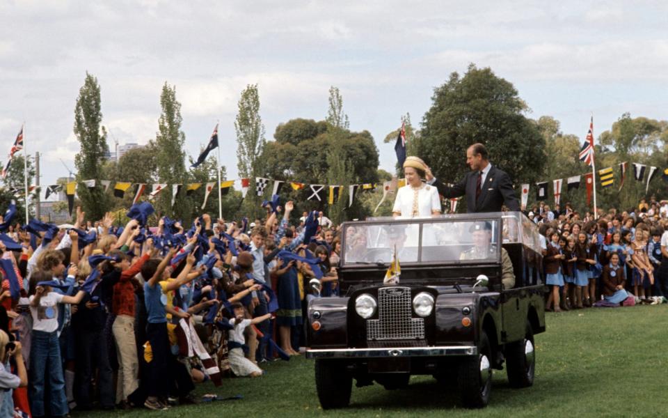 17/03/77 of Queen Elizabeth II and the Duke of Edinburgh in an open top Land Rover at a children's rally in Royal park, Melbourne - PA Wire