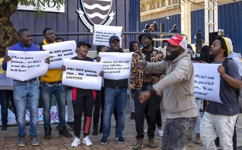 People protest against Coronavirus vaccine trials in Africa, outside the University of the Witwatersrand in Johannesburg, South Africa, Wednesday, July 1, 2020. A protest against Africa’s first COVID-19 vaccine trial is underway as experts note a worrying level of resistance and misinformation around testing on the continent.(AP Photo/Themba Hadebe)