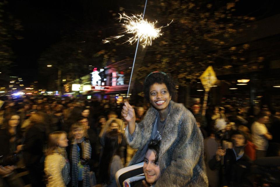 Crystal Davis, of Seattle, waves a sparkler as she celebrates the 2012 election with a large crowd in Seattle's Capitol Hill neighborhood, Tuesday, Nov. 6, 2012, in Seattle's Capitol Hill neighborhood. The re-election of President Barack Obama and Washington state's referendum 74, which would legalize gay marriage, drew the most supporters to the streets. (AP Photo/Ted S. Warren)