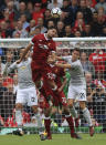 <p>Liverpool’s Emre Can soars to clear the ball</p>