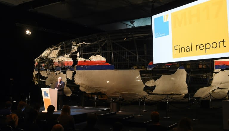 Dutch Safety Board Chairman Tjibbe Joustra speaks in front of the wrecked cockpit of the Malaysia Airlines flight MH17 during a presentation of the final report on the cause of the crash, at the Gilze Rijen airbase October 13, 2015