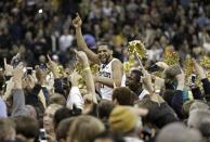 Wake Forest's C.J. Harris, center, celebrates with fans after their 80-65 win over second-ranked Miami in an NCAA college basketball game in Winston-Salem, N.C., Saturday, Feb. 23, 2013. (AP Photo/Chuck Burton)