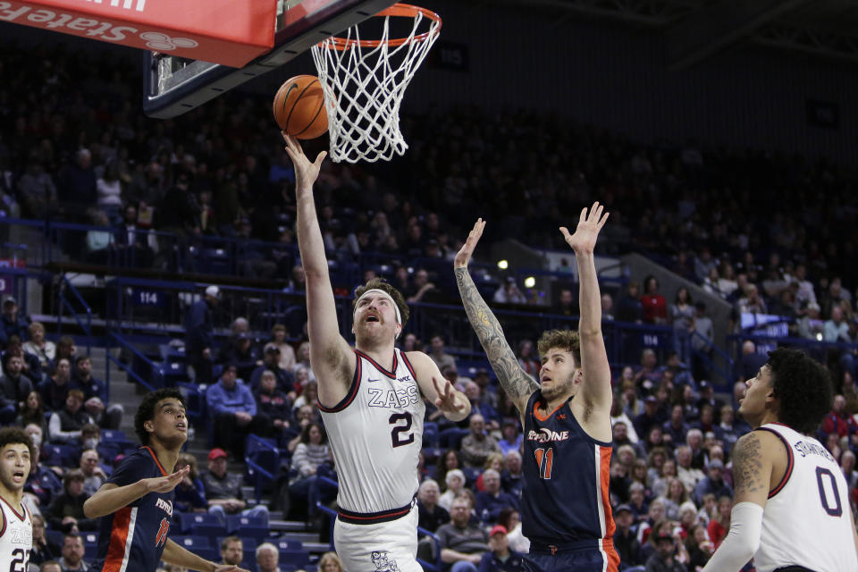 Gonzaga forward Drew Timme (2) shoots while defended by Pepperdine center Carson Basham (11) during the second half of an NCAA college basketball game, Saturday, Dec. 31, 2022, in Spokane, Wash. (AP Photo/Young Kwak)