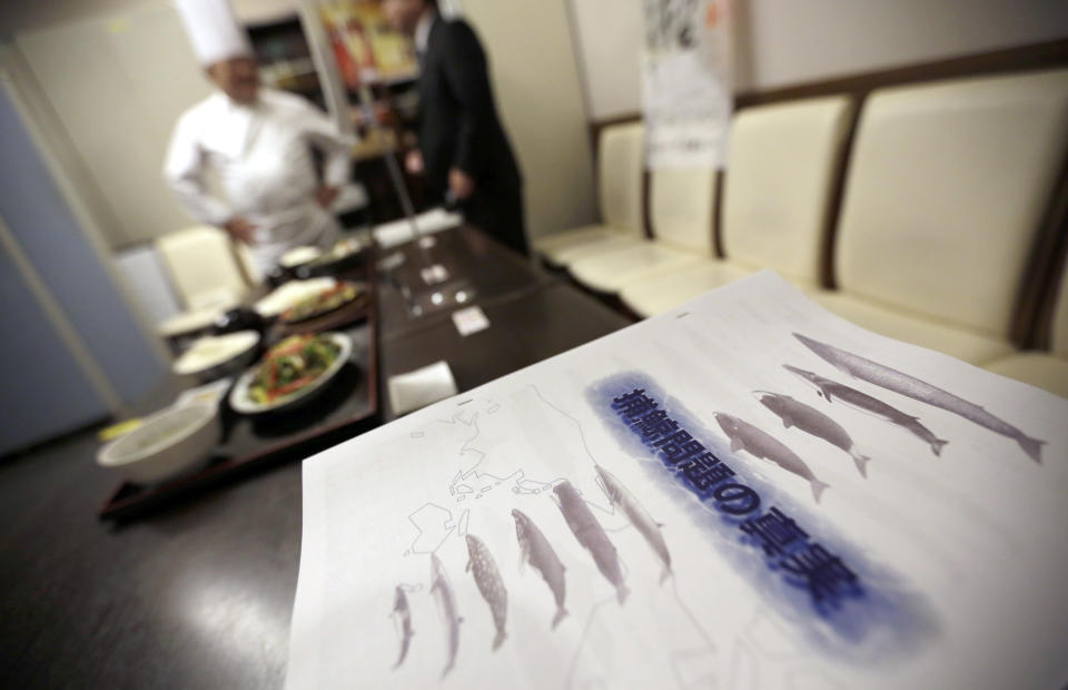 FILE - In this Nov. 19, 2014 file photo, booklets titled "The Truth of Whaling Problem" are placed next to whale meat dishes on display at a cafeteria of Ministry of International Trade and Industry in Tokyo as it started to serve whale meat. Japan announced Wednesday, Dec. 26, 2018, it is leaving the International Whaling Commission to resume hunting the animals for commercial use but said it will no longer go to the Antarctic for its much-criticized annual killings of hundreds of whales.(AP Photo/Eugene Hoshiko, File)