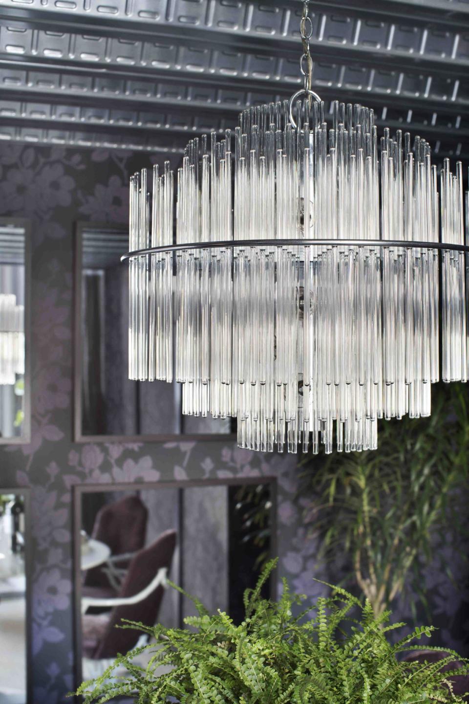 In this photo provided by Brian Patrick Flynn, to ensure safety, the designer Flynn had this 1960s era glass and chrome chandelier found for $150 at a flea market rewired before installing it in a dining room. Flynn suggests always splurging on electrical and upholstery updates to add longevity to vintage finds. (AP Photo/Brian Patrick Flynn/Flynnside Out Blog, Sarah Dorio)