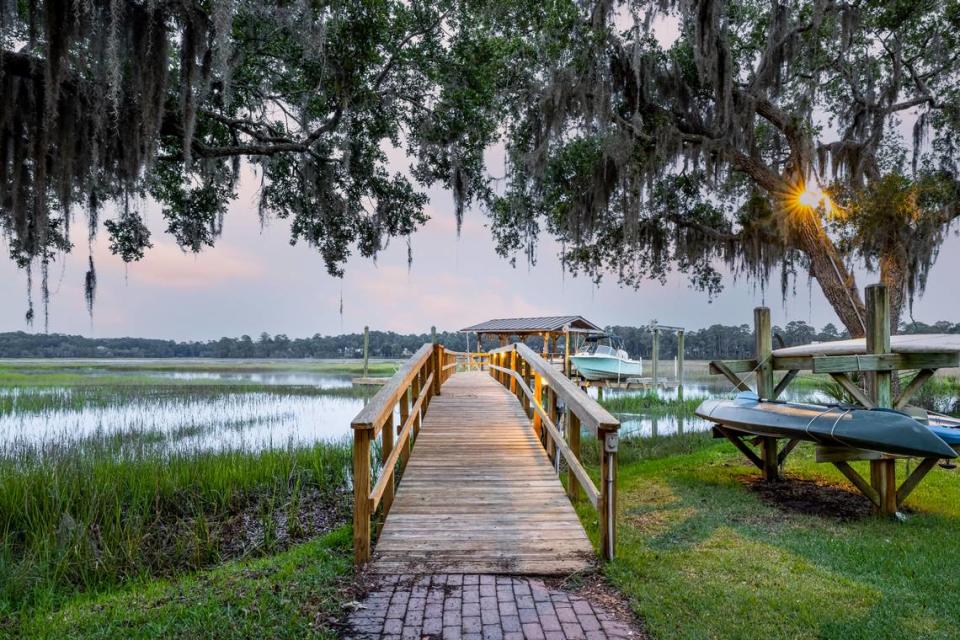 A pier and kayak/paddle board station view along the river at 95 Gascoigne Bluff Road in Bluffton, SC.
