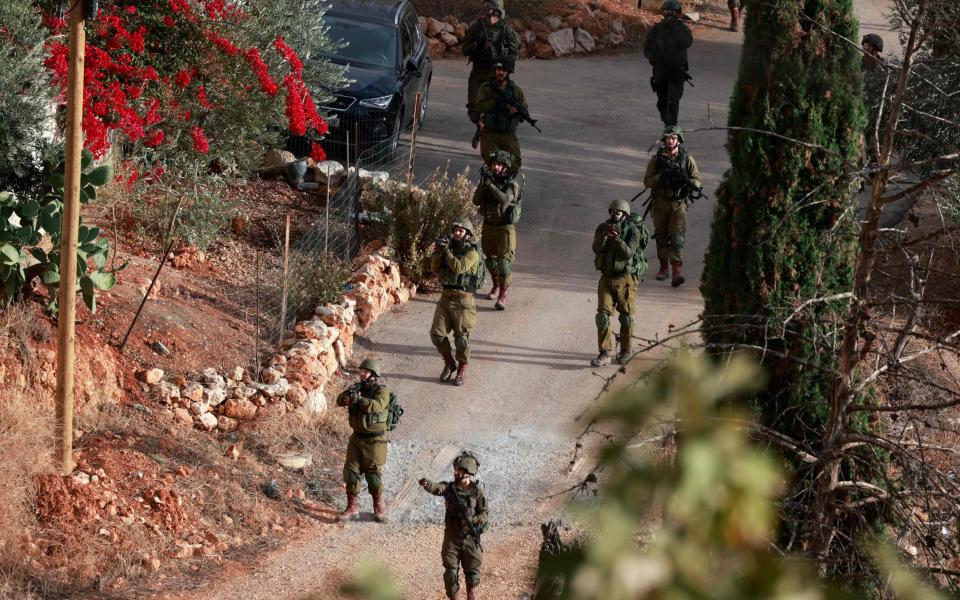 Israeli soldiers aim their rifles during a raid at the Balata camp for Palestinian refugees