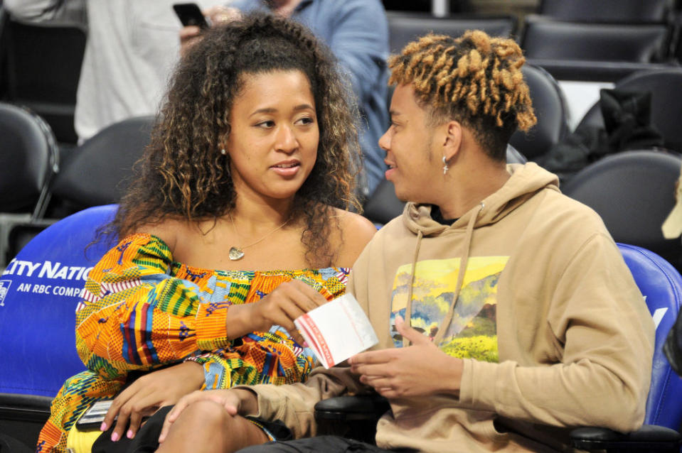 The couple sitting court side at a basketball game