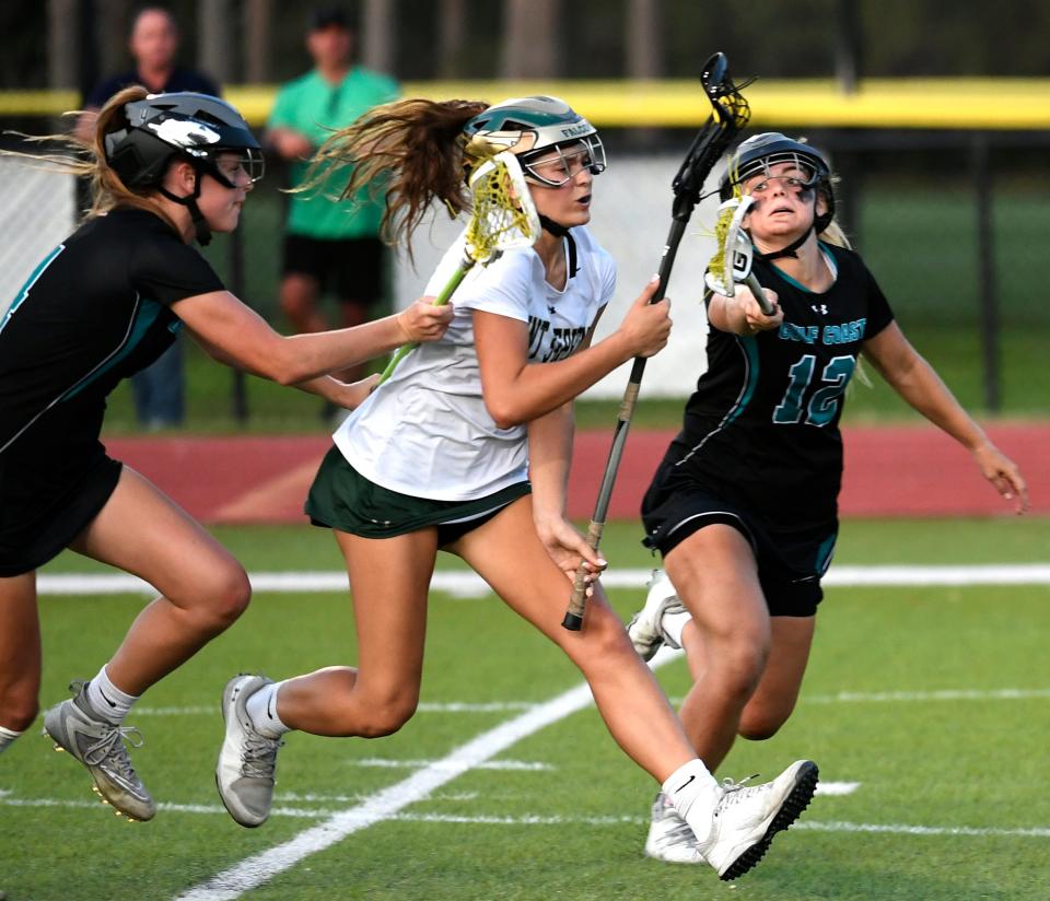 Saint Stephen's Sienna Cassella scores one of her five goals on Tuesday despite the efforts of Kali Cleary and Emma Masterson in the Falcons' 16-4 victory in a Class 1A-Region 3 lacrosse semifinal at Saint Stephen's.