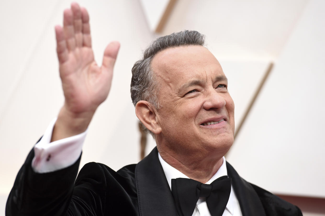 FILE - In this Sunday, Feb. 9, 2020 file photo, Tom Hanks arrives at the Oscars at the Dolby Theatre in Los Angeles. On Friday, May 15, 2020, The Associated Press reported on videos circulating online incorrectly asserting actor Tom Hanks and Chicago Mayor Lori Lightfoot support the “New World Order,” a conspiracy theory built on the idea that the world’s most wealthy and powerful are plotting to overthrow democracy and install a single, global authoritarian government. The clip featuring Hanks was taken from a five-minute video of him addressing the class of 2020 at Wright State University. (Photo by Jordan Strauss/Invision/AP)