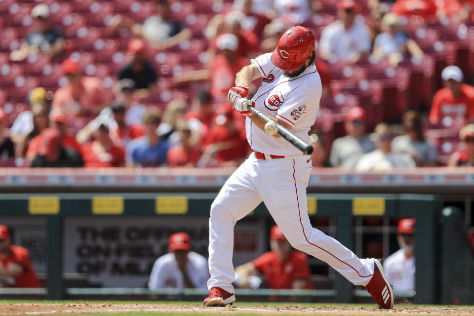 Cincinnati Reds' Wade Miley hits a two-run double during the second inning of the first baseball game of a doubleheader against the St. Louis Cardinals in Cincinnati, Wednesday, Sept. 1, 2021. (AP Photo/Aaron Doster)