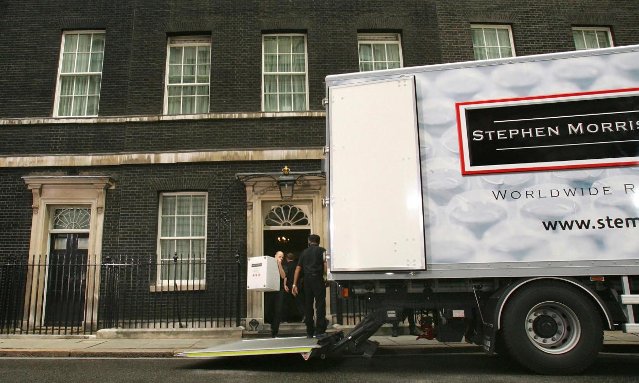 <span>A team from Stephen Morris Shipping move the Blairs out of Downing Street in 2007.</span><span>Photograph: Daniel Berehulak/Getty Images</span>